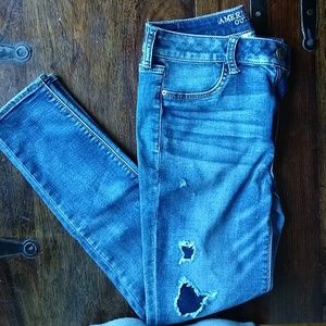 Distressed jegging with holes patched